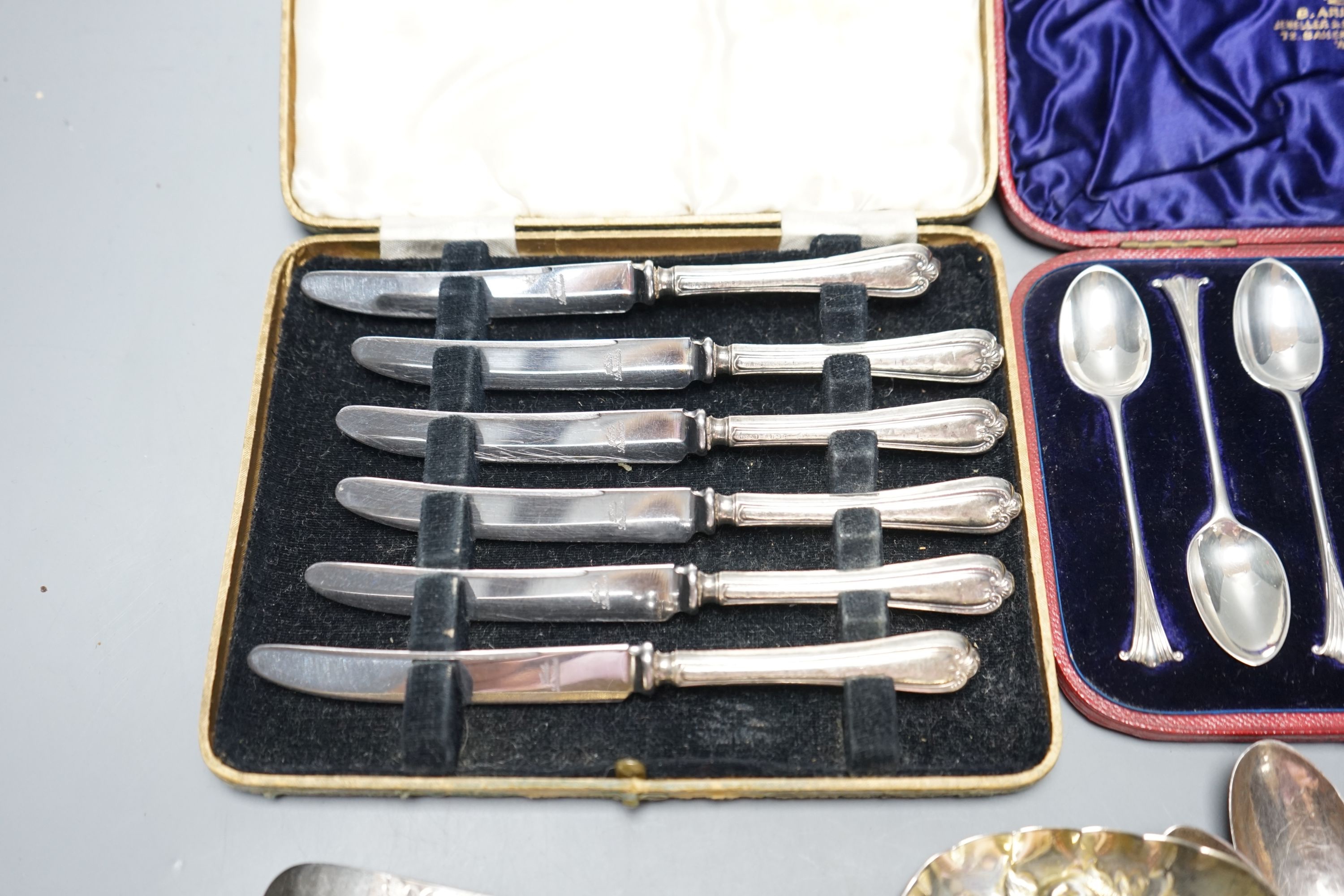 Two George III silver 'berry' spoons, seven other silver spoons, pair of silver tongs, a Swedish white metal teaspoons and two cased sets including silver teaspoons.